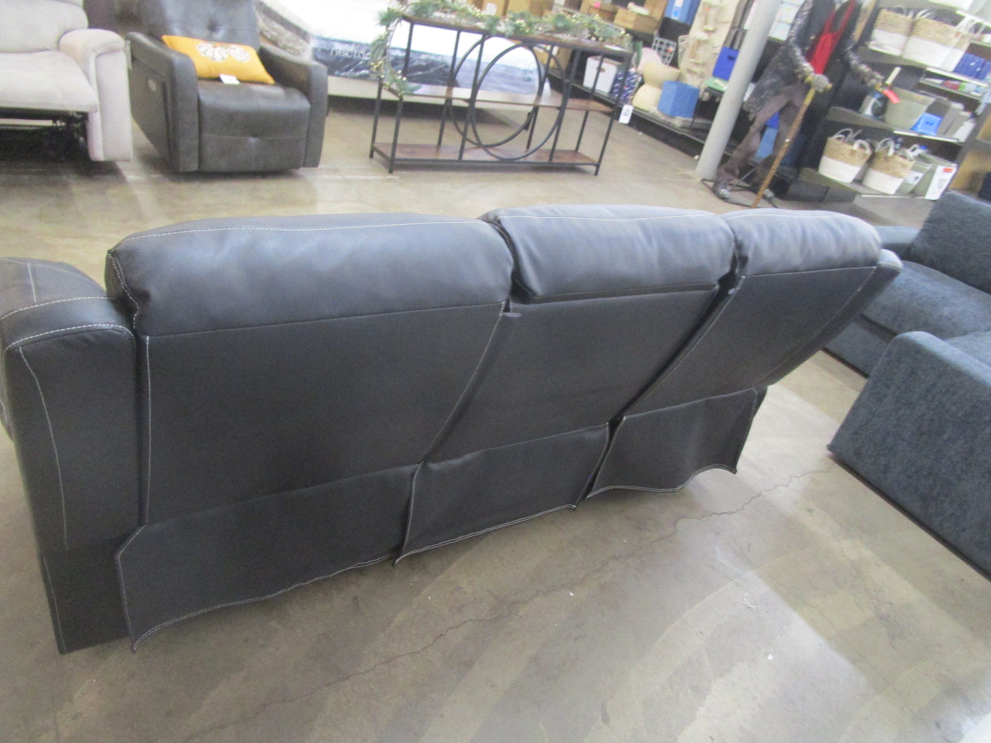 Black flaux leather sofa with cup holder.