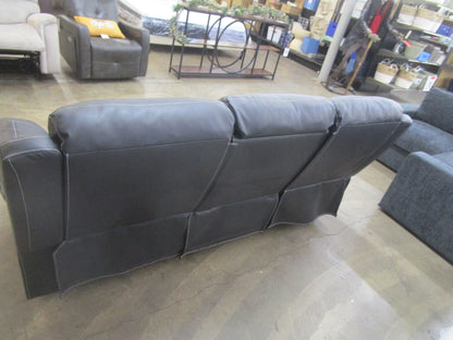 Black flaux leather sofa with cup holder.
